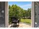 Charming balcony featuring wooded backyard views and wrought-iron railing at 30 Dorset Ct, Sharpsburg, GA 30277