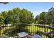Relaxing balcony with wicker furniture overlooking lush greenery and manicured lawns at 30 Dorset Ct, Sharpsburg, GA 30277