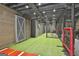 Finished basement area with a batting cage, perfect for sports enthusiasts and training at 30 Dorset Ct, Sharpsburg, GA 30277
