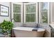 Primary bath with free standing tub, hardwood floors, mosaic tile backsplash and garden views at 30 Dorset Ct, Sharpsburg, GA 30277