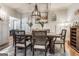 Open dining room featuring hardwood floors, rug, wainscoting and a rustic wood table at 30 Dorset Ct, Sharpsburg, GA 30277