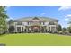 Beautiful two-story home with stone accents, balconies, and a well-manicured front lawn at 30 Dorset Ct, Sharpsburg, GA 30277