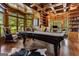 Bright game room featuring a pool table, wood-paneled walls and cabinetry, with large windows offering great natural light at 30 Dorset Ct, Sharpsburg, GA 30277