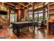 Spacious game room with beautiful wood finishes, pool table, and large windows offering great natural light at 30 Dorset Ct, Sharpsburg, GA 30277