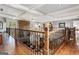 Second story view of a great room featuring a stone fireplace and beautiful hardwood floors at 30 Dorset Ct, Sharpsburg, GA 30277