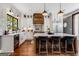 Modern kitchen features an island with seating, stainless steel appliances, and ample counter space, perfect for culinary enthusiasts at 30 Dorset Ct, Sharpsburg, GA 30277