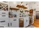 Elegant kitchenette featuring white cabinets, floating shelves, and a wine fridge, blending style and functionality at 30 Dorset Ct, Sharpsburg, GA 30277