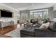 Comfortable living room with a plush grey sofa, bay window, and access to the outdoor patio through french doors at 30 Dorset Ct, Sharpsburg, GA 30277