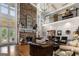 Impressive living room with a stone fireplace, soaring ceilings, and abundant light at 30 Dorset Ct, Sharpsburg, GA 30277