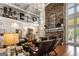 Inviting living room with a stone fireplace and open view to a balcony at 30 Dorset Ct, Sharpsburg, GA 30277