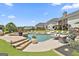 A backyard with a freeform pool, spa, and an outdoor lounge area at 30 Dorset Ct, Sharpsburg, GA 30277