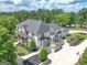 Expansive home featuring an entertainment patio, manicured landscaping, and a private driveway at 30 Dorset Ct, Sharpsburg, GA 30277