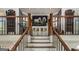 Staircase with oak railing, dark spindles, and decor niche at top of landing at 30 Dorset Ct, Sharpsburg, GA 30277