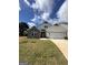 Charming two-story home featuring a stone facade and a well-manicured lawn with ample natural light at 11156 Cornerstone Way, Hampton, GA 30228