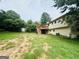 Backyard featuring a raised wooden deck with stairs, a shed, and a partially fenced in lawn at 1766 Tilden Ave, Jonesboro, GA 30236