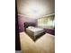 Purple bedroom featuring a tufted headboard, carpet floors, and a window with floral curtains at 1766 Tilden Ave, Jonesboro, GA 30236