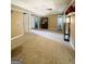 Large living room with neutral walls, carpet floors, many doors, and a black shelving unit at 1766 Tilden Ave, Jonesboro, GA 30236