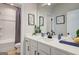 Well-lit bathroom with a modern vanity, framed mirror, and coordinated accessories at 37 Fraser Ln # 122B, Auburn, GA 30011