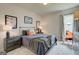 Cozy bedroom featuring soft carpet, stylish art, and a comfortable bed with decorative pillows at 37 Fraser Ln # 122B, Auburn, GA 30011