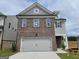 Charming two-story home features brick and siding exterior with an attached two-car garage at 37 Fraser Ln # 122B, Auburn, GA 30011
