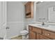 A half bathroom with wood cabinets, a white sink, and modern fixtures at 106 Lanyard Bnd, Peachtree City, GA 30269
