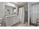 Bright bathroom featuring a shower with a shower curtain and a vanity sink at 106 Lanyard Bnd, Peachtree City, GA 30269