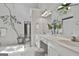 Bright bathroom featuring double sinks, white cabinets, vanity, and potted tree at 106 Lanyard Bnd, Peachtree City, GA 30269