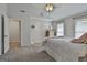 Well-lit primary bedroom with neutral walls, carpet, ceiling fan and minimalist decor at 106 Lanyard Bnd, Peachtree City, GA 30269