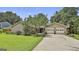 Charming single-story home featuring a two-car garage, a well-maintained lawn, and a basketball hoop on the driveway at 106 Lanyard Bnd, Peachtree City, GA 30269