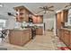 Open-concept kitchen with wood cabinets, granite counters, stainless appliances, and hardwood floors at 106 Lanyard Bnd, Peachtree City, GA 30269