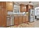 The kitchen has wooden cabinets, stainless steel appliances, and a floral rug at 106 Lanyard Bnd, Peachtree City, GA 30269