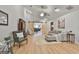 Bright living area featuring high ceilings, wood floors, comfortable seating, a statement TV console, and barn door entry at 106 Lanyard Bnd, Peachtree City, GA 30269