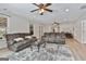 A spacious living room, lit with natural light and ceiling fans, and cozy seating at 106 Lanyard Bnd, Peachtree City, GA 30269