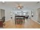 Open concept living room with hard wood floors and dining table at 106 Lanyard Bnd, Peachtree City, GA 30269