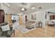 Bright living area featuring high ceilings, wood floors, comfortable seating, barn doors, and ample natural light at 106 Lanyard Bnd, Peachtree City, GA 30269
