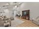 Bright living room featuring vaulted ceilings, a large television, wood flooring, and comfortable seating arrangements at 106 Lanyard Bnd, Peachtree City, GA 30269