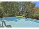 Inviting swimming pool with slide and clear blue water, surrounded by lush greenery at 106 Lanyard Bnd, Peachtree City, GA 30269