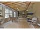 Spacious partially finished sun room with an unfinished wooden floor and large windows at 106 Lanyard Bnd, Peachtree City, GA 30269