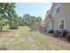 Expansive backyard with mature trees, green grass, and a fenced patio at 115 Sunderland Cir, Fayetteville, GA 30215
