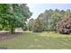 Expansive backyard featuring mature trees and lush green lawn at 115 Sunderland Cir, Fayetteville, GA 30215