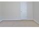 A light filled bedroom with neutral carpet and door at 115 Sunderland Cir, Fayetteville, GA 30215