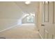 Bright bonus room features neutral carpeting, angled ceilings, a ceiling fan and great natural light at 115 Sunderland Cir, Fayetteville, GA 30215