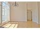 Spacious dining room with hardwood floors, chandelier, large windows, and bright natural light at 115 Sunderland Cir, Fayetteville, GA 30215