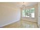 Dining room with hardwood floors, modern lighting fixture and a bright window overlooking the backyard at 115 Sunderland Cir, Fayetteville, GA 30215
