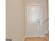 A well-lit entryway showcases a secure, solid front door at 115 Sunderland Cir, Fayetteville, GA 30215