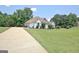 Spacious home with long driveway, lush lawn, and well-maintained landscaping at 115 Sunderland Cir, Fayetteville, GA 30215