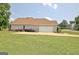 Home with attached garage, concrete driveway, and well-maintained landscaping at 115 Sunderland Cir, Fayetteville, GA 30215