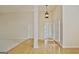 Inviting foyer featuring hardwood floors, bright lighting, and an entrance to the main living areas at 115 Sunderland Cir, Fayetteville, GA 30215