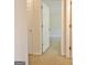 Hallway view looking into a carpeted bedroom with white trim at 115 Sunderland Cir, Fayetteville, GA 30215