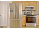 This kitchen features wooden cabinets and stainless steel appliances at 115 Sunderland Cir, Fayetteville, GA 30215